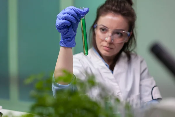 Investigadora química mujer sosteniendo tubo de ensayo con líquido de ADN — Foto de Stock