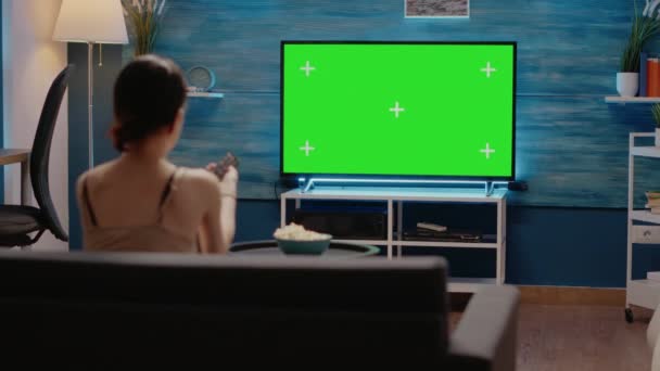 Young adult watching green screen display on television — Stock Video