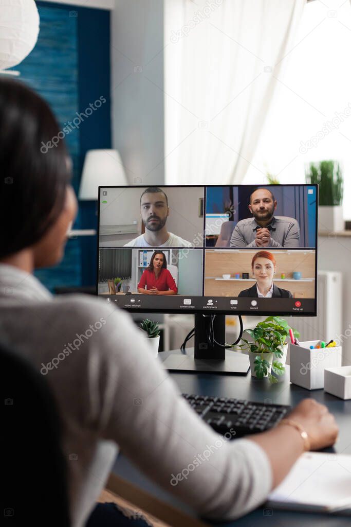 Black woman sitting at desk working remote at marketing course ideas