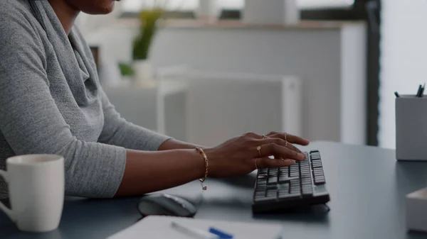 Closeup of african american student hands typing information for communication project — Stock Photo, Image