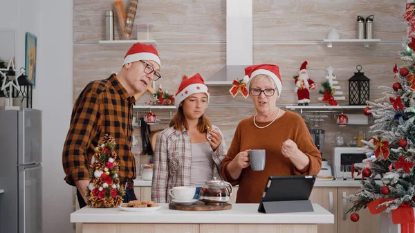 Grandparents with granddaughter greeting remote friends during online videocall meeting — Stock Photo, Image