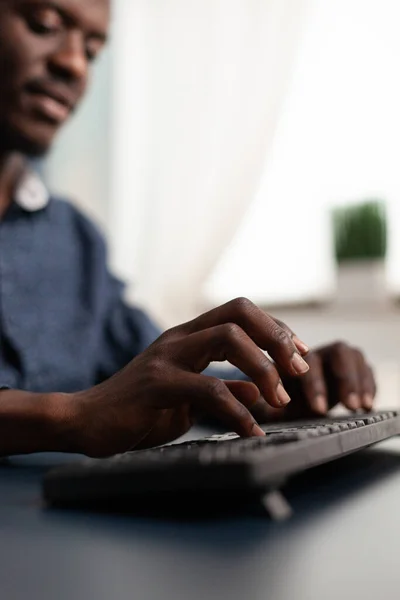 Black african american person typing on PC keyboard — Stock Photo, Image