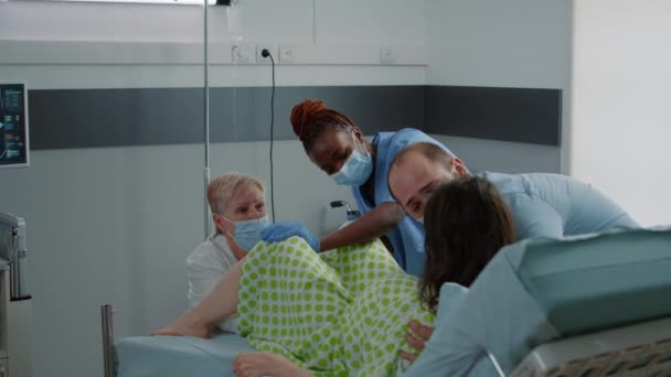 Молодая женщина толкает во время родов в больничной палате — стоковое видео