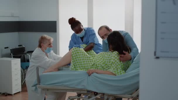 Obstetrician and african american nurse delivering baby — Stock Video