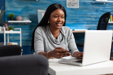 African american student making online sale shopping holding economy credit card in hands