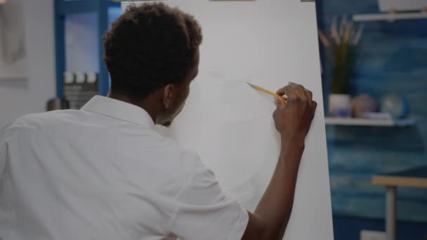 젊은 흑인 미술가 가화 병그리기를 위해 캔버스에 미술 연필을 사용하는 모습 — 비디오