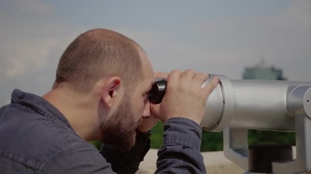 Teleskop merceğinden bakan beyaz adama yaklaş. — Stok video