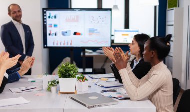 Gülümseyen seyirciler bir iş seminerinde alkışlıyorlar.