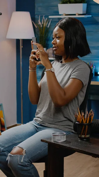 African american girl taking picture of drawing using smartphone — Stock Photo, Image