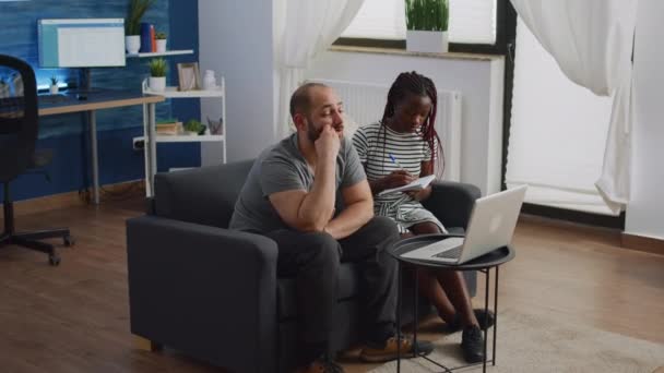 Young interracial couple planning budget for tax payment — Stock Video