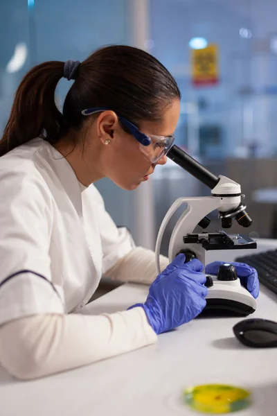 Biochemist working on microscope for cell illustration — Stock Photo, Image