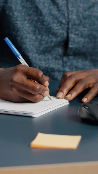 Closeup african american black man hands taking notes on notepad using a pen — Stock Photo, Image