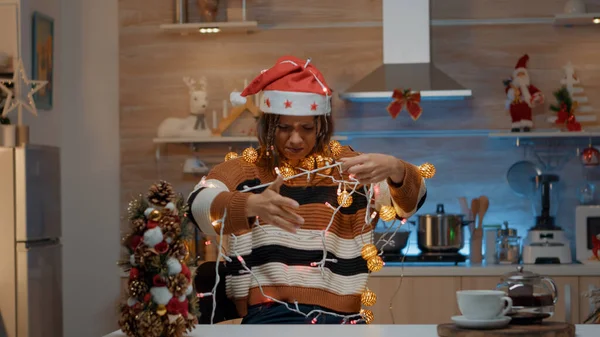 Woman decorating kitchen with festive ornaments — Stock Photo, Image