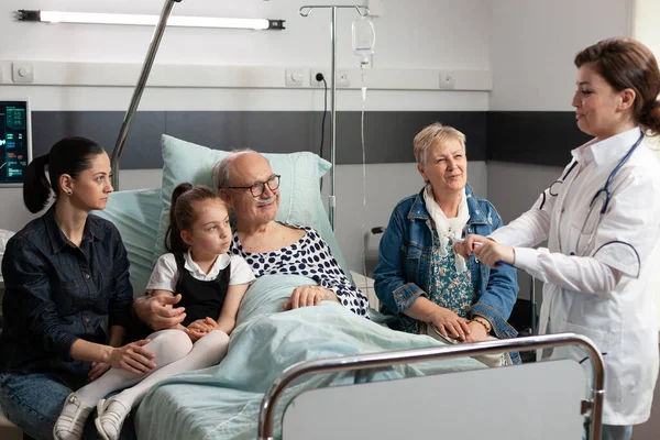 Artsen controleren bejaarde zieke oude patiënt verklaren ziektesymptomen — Stockfoto