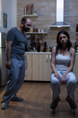 Kızgın şiddet yanlısı bir adam mutsuz bir kadını tehdit ediyor.