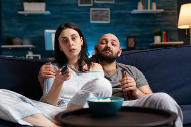 Genç çift geceyi pijama giyerek birlikte geçiriyorlar. Birlikte vakit geçirmenin tadını çıkarıyorlar.