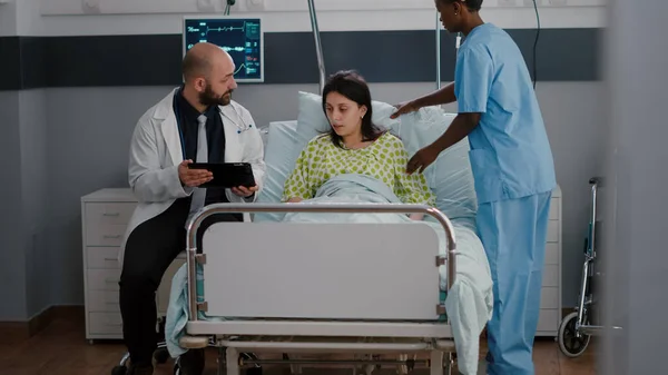 Practitioner physician doctor explaining disease expertise to sick woman — Stock Photo, Image