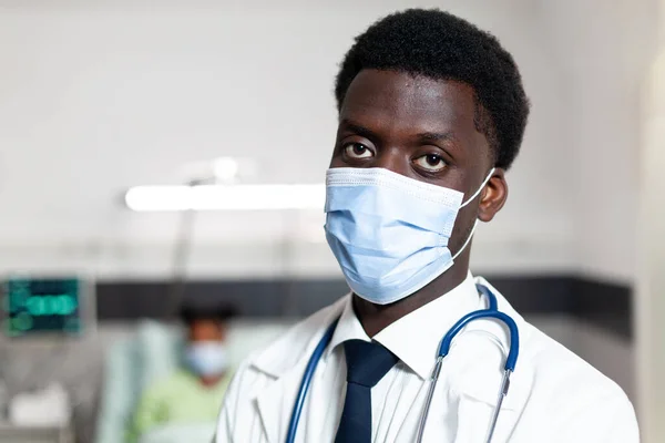 Close up of african american doctor standing in hospital ward — Stock Photo, Image