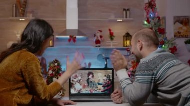 Bir çift Noel arifesinde ailesiyle görüntülü konuşma yapıyor.
