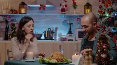 Erkek ve kadın Noel 'i şenlikli bir akşam yemeğinde kutluyorlar.