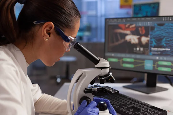 Biochemist working on microscope for cell illustration — Stock Photo, Image