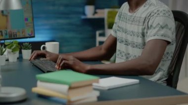 Grafik tasarımcısı kulaklık takıyor ve resimleri rötuşluyor.