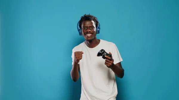 Happy man winning at video games with joystick on console — Stock Photo, Image