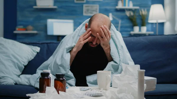 Close up of sick adult with headache rubbing temples — Stock Photo, Image