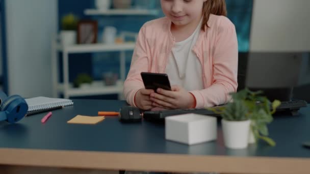 Criança alegre olhando para smartphone com tela sensível ao toque — Vídeo de Stock