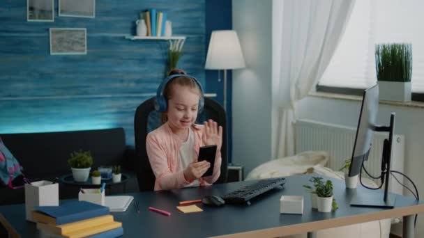 Little girl using smartphone for lessons on video call — Stock Video