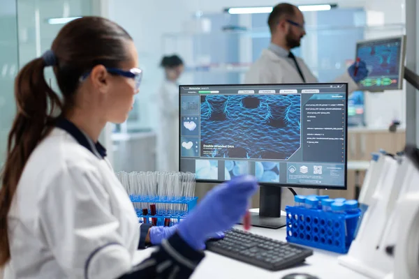 Specialist biologist researcher holding blood medical test tubes analyzing virus diagnostic expertise — Stock Photo, Image