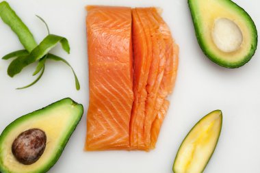 Suşi ve beyaz tahta üzerinde avokado için taze balık