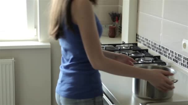 Frau kocht Wasser zum Abendessen — Stockvideo