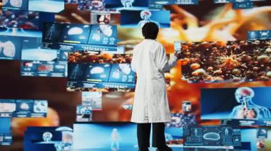 Fütüristik CT taramaları, MRI verileri ve video baykuşlarında gösterilen laboratuvar analizleriyle sağlık uzmanları büyülendi. Tıp araştırma laboratuarındaki bilim adamı yüksek teknoloji panellerindeki sağlık verileri karşısında hayrete düştü.