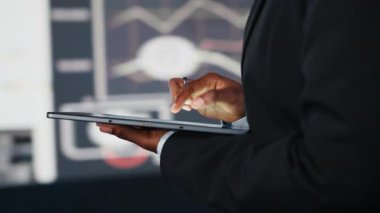 Karar vermeden önce KPI şirketinin dijital video baykuş verilerini karşılaştırmak için tablet kullanan iş kadınını kapatın. Girişimci aygıt uygulaması kullanarak anahtar performans göstergelerini analiz ediyor