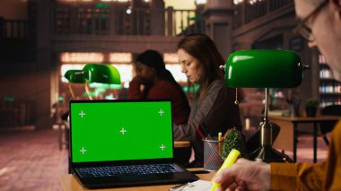 Üniversitedeki bilgisayar üzerinde kroma anahtarı olan akademik metin okuyan, klasik çalışma alanında oturan ve çevrimiçi derslere göz atan son sınıf öğrencisi. Bilgi ve hırs..