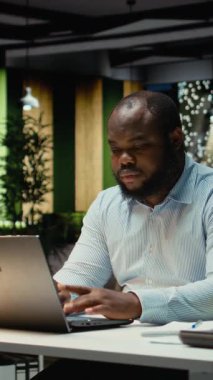 Dikey Afrikalı Amerikalı adam mesaiden sonra bitkin ve bunalmış hissediyor, tükenme belirtilerine rağmen sınırları zorluyor. İş yerindeki zorluklar ve stres fazla mesai nedeniyle rahatsızlık yaratıyor. Kamera A