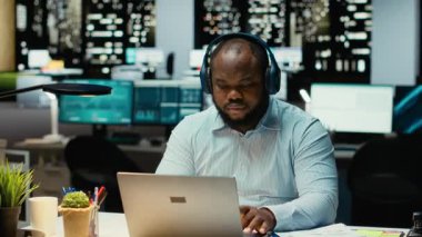 Siyahi insanlar, kulaklık üzerine odaklanmış müzik eşliğinde günlük işleri yürütüyor, ortam sesleriyle ilham buluyor, konsantrasyon ve verimliliğe yardımcı oluyor. Erkek işçi birden fazla iş yapıyor. Kamera B.