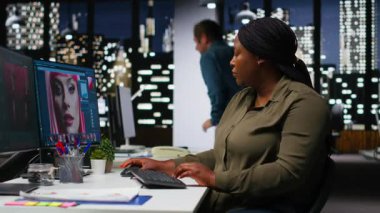 Kadın editör, modern çalışma ortamında çift monitörlü fotoğrafçılık için oluşturulmuş yapay zeka içeriği üzerinde çalışıyor. Yaratıcı bir kariyer için yazılım ve sanal asistan alınıyor. Kamera B.