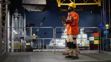 Siyah denizaşırı işçiler petrol platformunda sondaj sondajı güvenliğini artırmak için modern teknoloji ve dizüstü bilgisayar kullanarak risk değerlendirmesi yapıyorlar. Fosil yakıtlar ve doğal gaz çıkarma. Kamera A.