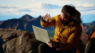 Yürüyüşçü sert rüzgarlara ve çevrim içi kalmak için soğuk havaya meydan okuyor. Rüzgarlı ve riskli doğada kamp kuruyor. Teknoloji bağımlılığı olan bir kaşif dağın tepesine bile bağlanmış. Kamera A.