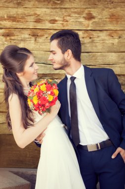Young bride and groom looking at each other with love