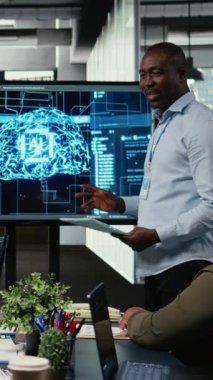 Dikey video programcısı, Yapay Zeka Chatbot uygulamasının iş hacmini azaltmasıyla yöneticilere sunum yapıyor. Girişim bürosu bilişim uzmanı suni kullanım kullanılarak yönetimin iş görüşlerini analiz ediyor