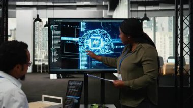 Yatırımcılar için sunum yapan teknik girişim yöneticisi yapay zekaya derin dalış yapmak için toplantı odasında toplandı. Yapay zeka sektöründeki son yenilikleri sergiliyor.