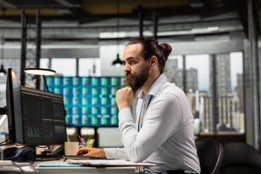 İnsan, analitik ve performans ölçümlerini bilgisayarda incelerken, iş stratejisi ve yenilikleri yönlendirirken hedefler, başarı ve başarı üzerine odaklanmış profesyonel bir zihniyeti de koruyor.