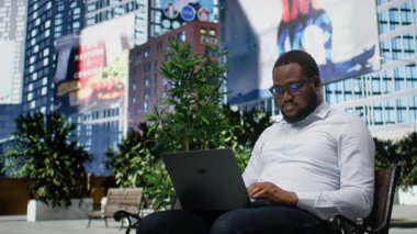 Afro-Amerikan erkek hayal kırıklığına uğramış ve üzgün bir şekilde şehir bankında oturuyor, hoşnutsuz ve dizüstü bilgisayarla ilgili. Şehir mimarisi ve şehir hayatının ritmiyle çevrelenmiş. Kamera A.