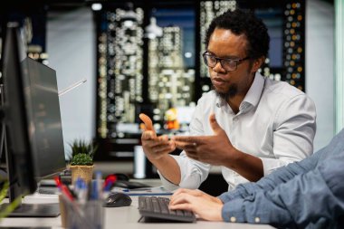 Teknisyenler başlangıç ofisinde sohbet ediyorlar, gelişmiş makine öğrenme modellerini kodlayıp otomasyonu geliştiriyorlar. Silikon Vadisi iş yeri bilişim uzmanları masadaki yapay zekayı kullanarak tartışıyorlar.