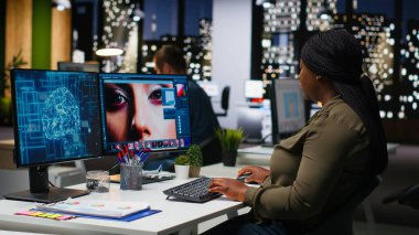 Afro-Amerikalı kadın fotoğrafçı, fotoğraf düzenlemek için nöral ağ sistemi kullanıyor, yapay zekayla profesyonel içerik yaratıyor. Bilgisayar üzerinde rötuş yapmak için yapay zeka yazılımı. Kamera B.