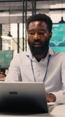 Dikey Video Siyah Adam çalışanı, parasal veriler, performans değerlendirmesi, dizüstü bilgisayar, kurumsal çalışma alanı, analitik gösterge paneli, kaynak tahsisi, verimlilik, küresel iş başarısı. İş bilgileri.