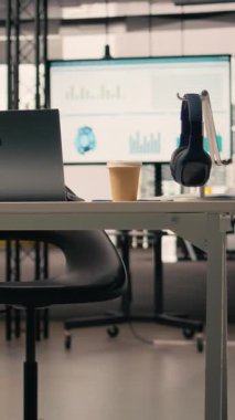 Dikey Video İşletme, modern masa boş, profesyonel ofis malzemeleri ve mobilyalar, kırtasiyeli rahat yönetim alanı. Pencereler doğal ışık, parlak açık alan sağlar